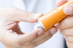 Image of someone applying a topical pain relieving cream