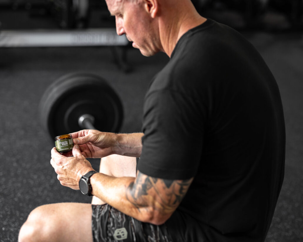 man using musclemud to help his muscles recover faster after a workout